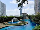 Luxurious outdoor swimming pool surrounded by high-rise buildings