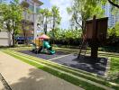 Well-maintained playground surrounded by lush greenery in residential complex