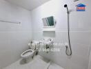 Clean and tiled bathroom with shower and toilet