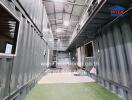 Industrial container-based corridor in a property, featuring metal walls and modern structure