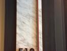 Elegant apartment door with marble finish and modern numbering