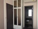 Bedroom with dark wardrobe, white folding doors, and air conditioning unit