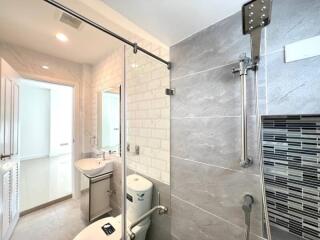 Modern bathroom with grey tiles and glass shower