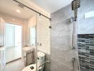 Modern bathroom with grey tiles and glass shower