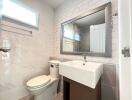 Modern bathroom with white marble tiles and sleek fixtures