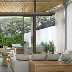 Modern living room with large windows and nature view
