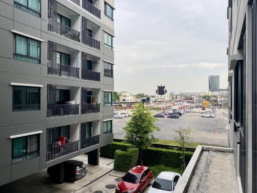 View from apartment building showing parking lot and urban surroundings