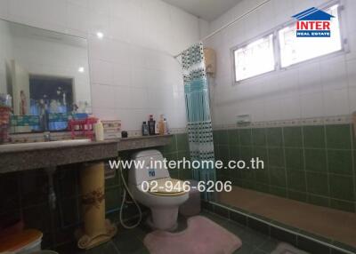 Spacious bathroom with detailed tile work and ample counter space