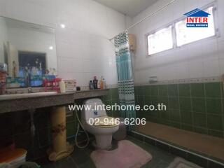 Spacious bathroom with detailed tile work and ample counter space