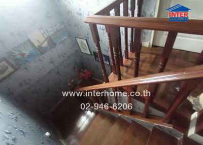 Elegant wooden staircase with decorative wallpaper in a home