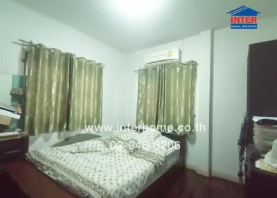 Spacious bedroom with ample natural light and air conditioning