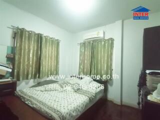 Spacious bedroom with ample natural light and air conditioning