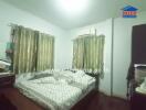 Spacious bedroom with ample natural light and air conditioning