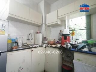 Cluttered kitchen with natural light