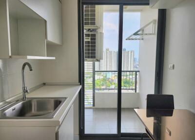 Modern kitchen with city view through balcony