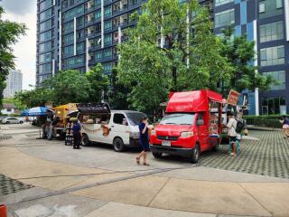 Street view with food trucks and residential building