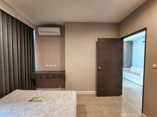 Spacious bedroom with modern furnishings and balcony access