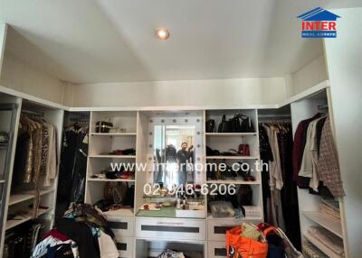 Spacious walk-in closet with ample storage and central dressing area