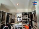 Spacious walk-in closet with ample storage and central dressing area