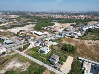 Aerial view of a suburban area showing residential and undeveloped land