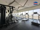 Modern gym interior with extensive range of equipment and panoramic city views