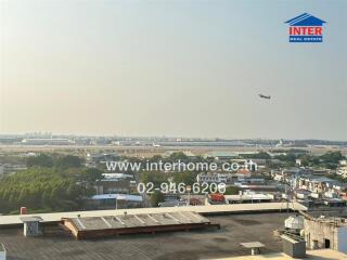 Panoramic view of cityscape with airplane in the sky