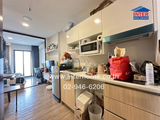 Compact modern kitchen in an apartment with a clear view to a living area