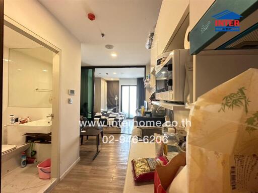 Compact kitchen with through view to the living room in a modern apartment