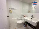 Modern bathroom with white tiles and essential amenities
