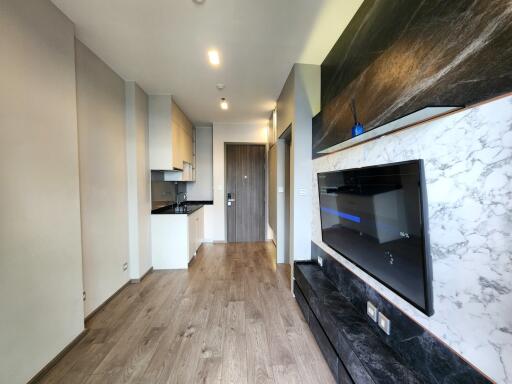 Modern kitchen with marble accents and hardwood flooring in a contemporary apartment