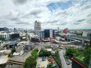 Cityscape view from a high-rise building showing urban skyline and construction