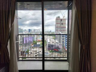 Bedroom with a city view and balcony access