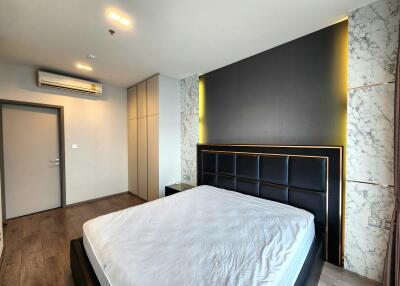 Modern bedroom with marble accents and ample lighting