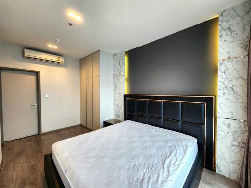 Modern bedroom with marble accents and ample lighting