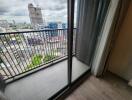 Spacious balcony with city view and sliding glass doors