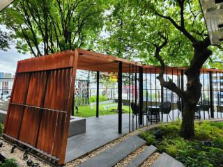 Modern outdoor patio with wooden pergola and stylish seating in an urban garden setting