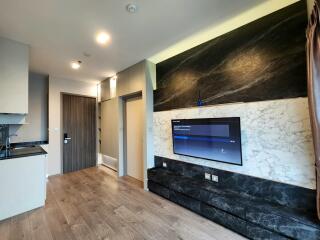 Modern living room interior with integrated kitchen and marble accents