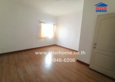 Spacious empty bedroom with natural light