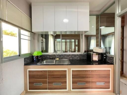 Modern kitchen with wooden cabinets and mosaic backsplash