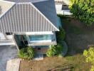 Aerial view of a modern residential house with landscaped garden
