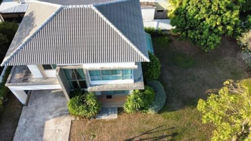 Aerial view of a modern residential house with landscaped garden