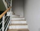 Modern staircase with wooden steps and white balustrade