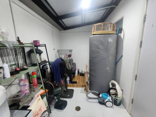 Cluttered home garage space with storage and laundry area