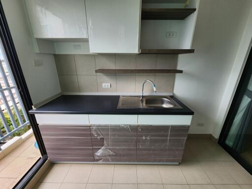 Compact modern kitchenette with natural lighting