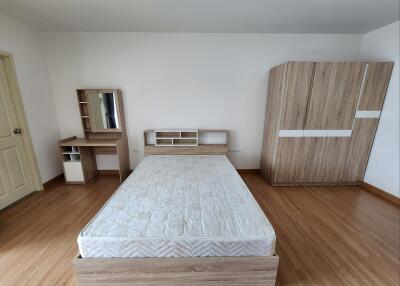Spacious bedroom with wooden furniture