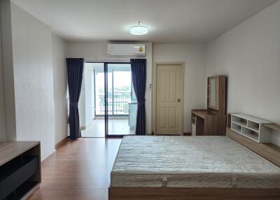 Spacious bedroom with large bed and balcony access