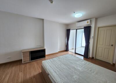 Spacious bedroom with large bed and access to balcony