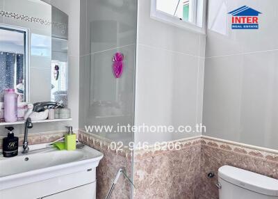 Well-lit bathroom with modern amenities