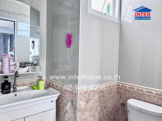 Well-lit bathroom with modern amenities