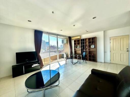 Spacious and bright living room with large windows and balcony access